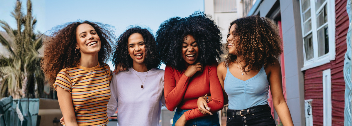 Curly haired friends laughing