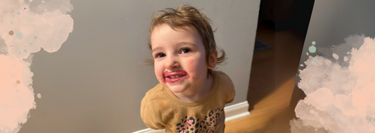 Little girl with lipstick on her face