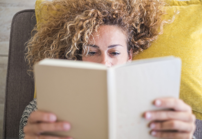 curly haired woman reading